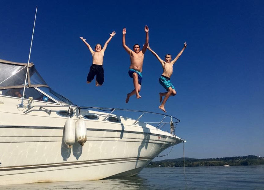 kids jumping off boat