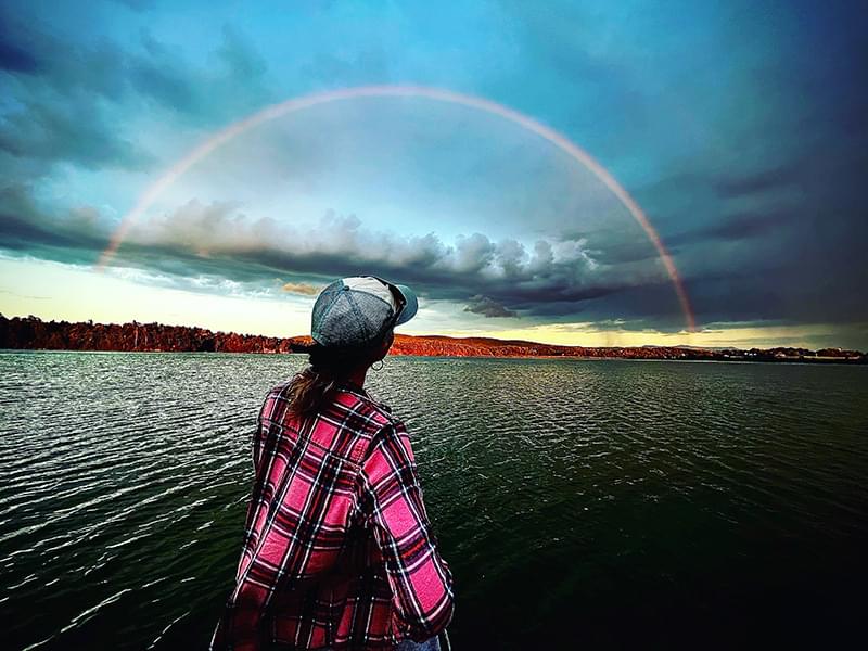 woman watching rainbow