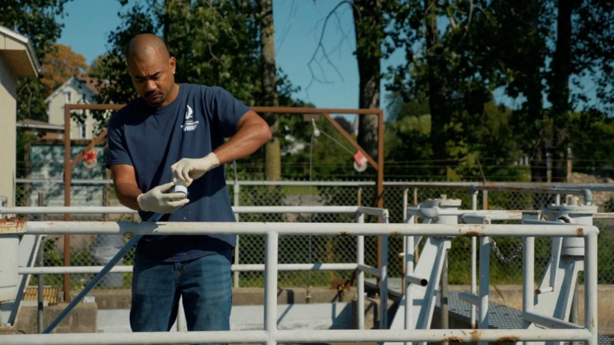 Technician taking samples at wastewater treatment facility