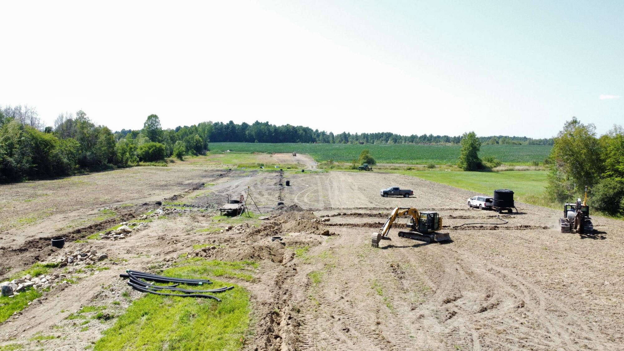 A plot of agricultural land with several construction vehicles